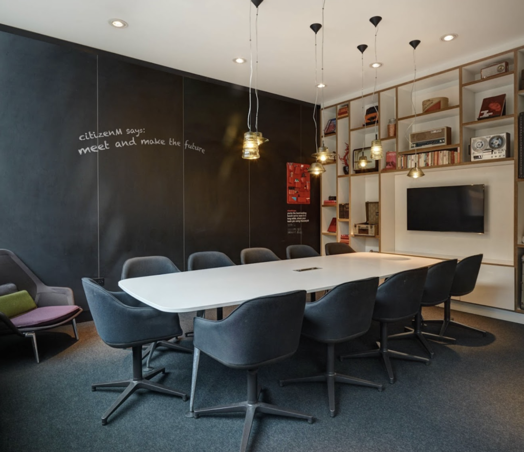 A modern meeting room with chalkboard walls.