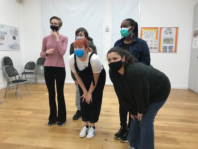 Group of people wearing face masks in theatre activity