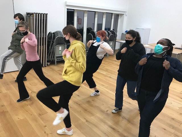 Group of young people in theatre activity workshop
