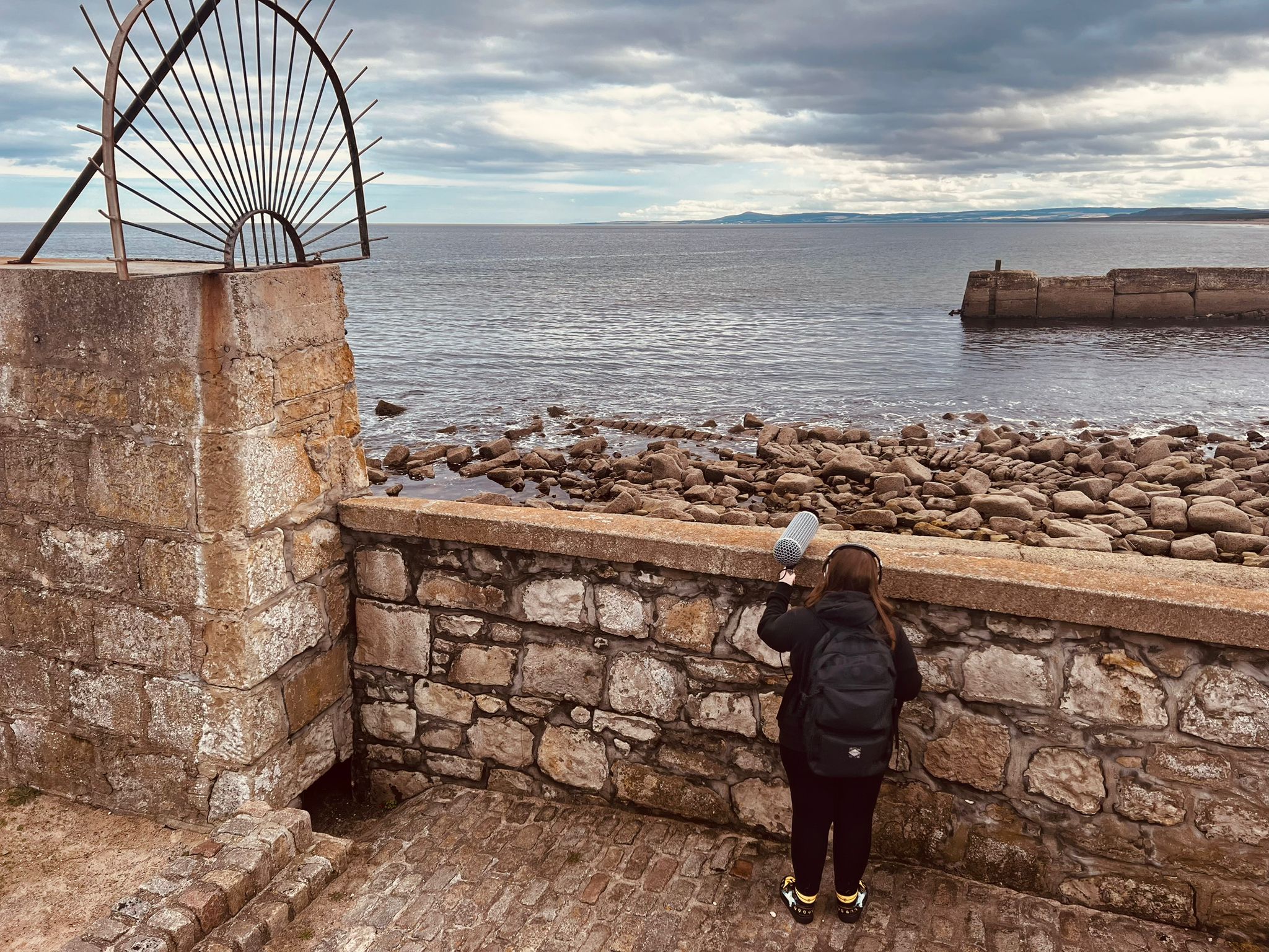 Young person peering over castle wall