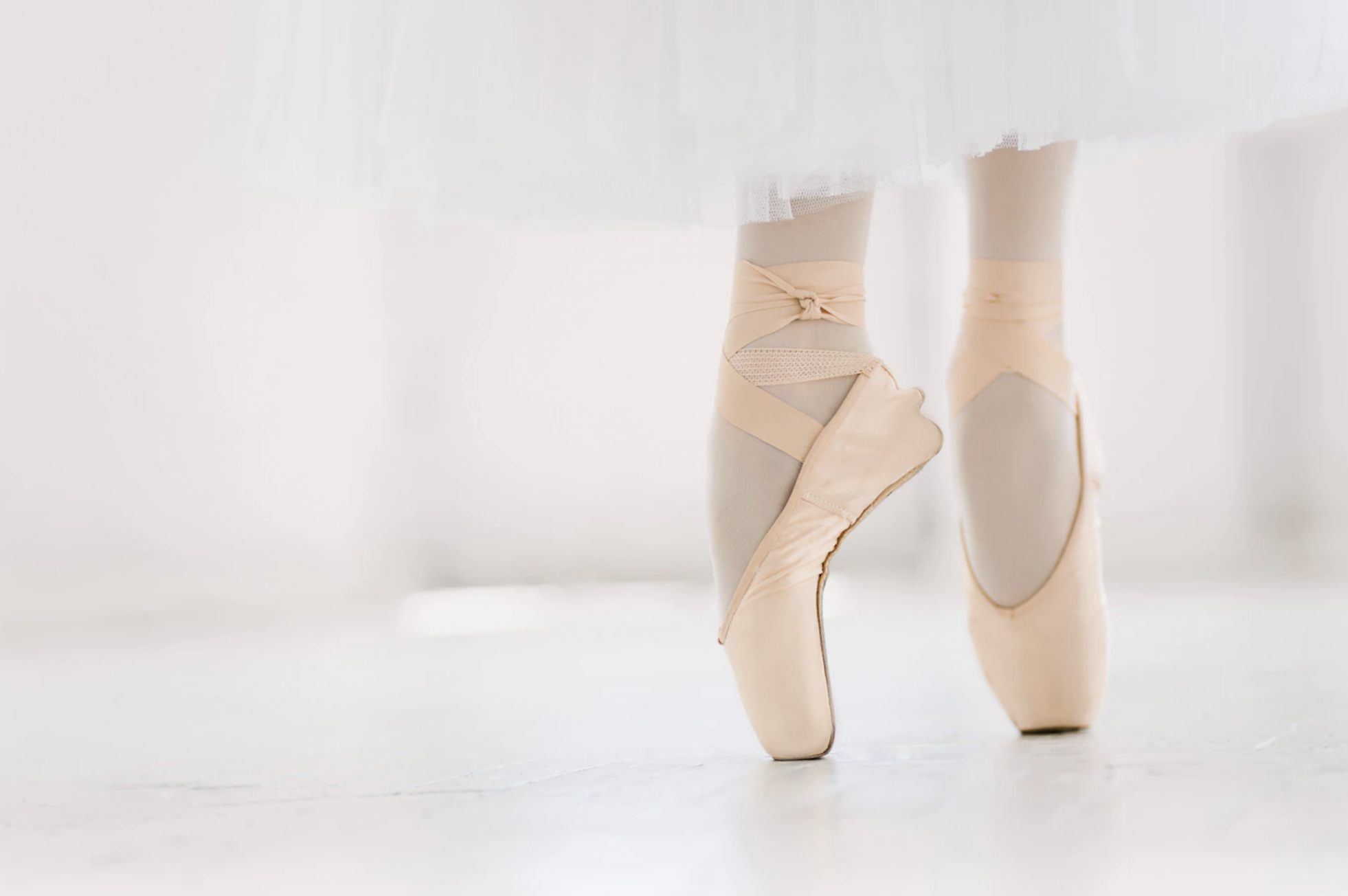 Someone standing with ballet shoes en point
