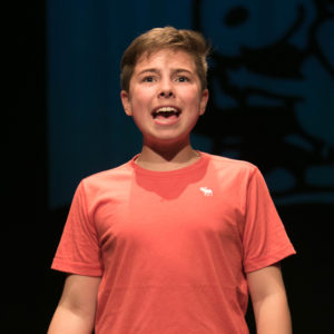 Young person singing on stage