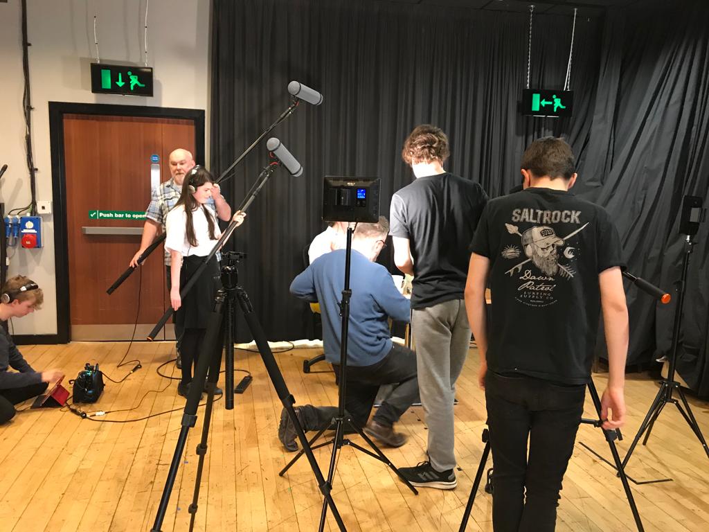 A group of young people with filming equipment