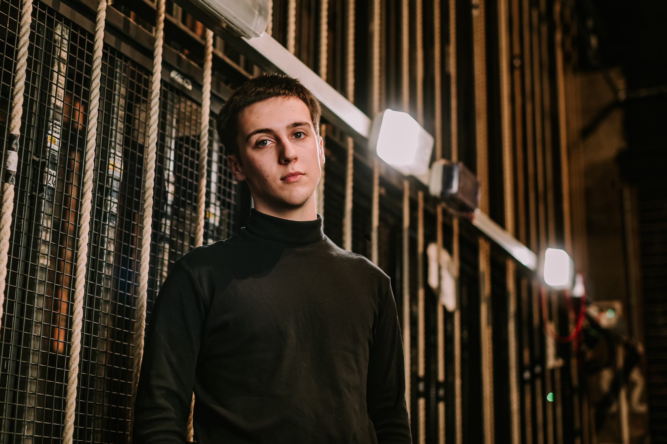Young man in front of stage lighting