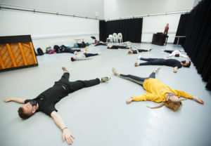 Young people in drama studio lying on the floor